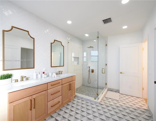 full bath featuring a shower stall, visible vents, a sink, and tile patterned floors