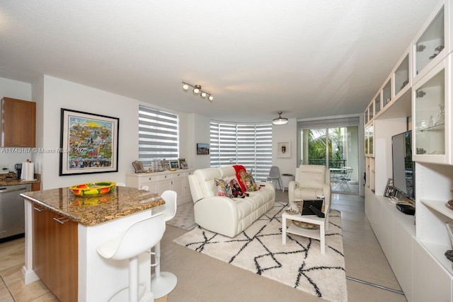 tiled living room featuring a textured ceiling