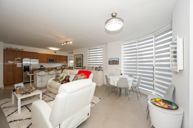 living area featuring light tile patterned flooring