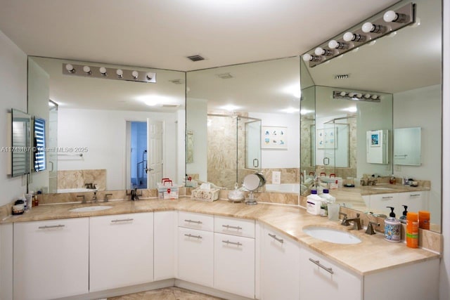 full bathroom featuring a shower stall, double vanity, visible vents, and a sink