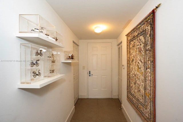 hallway with dark tile patterned floors