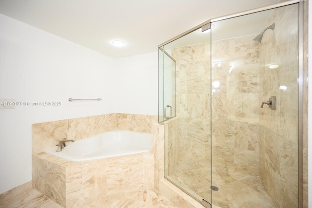 full bath with a bath and a shower stall