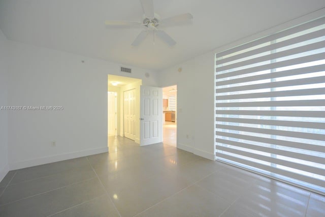 510 NW 84th Ave Unit 409, Plantation, FL 33324 - tiled spare room featuring a ceiling fan and baseboards