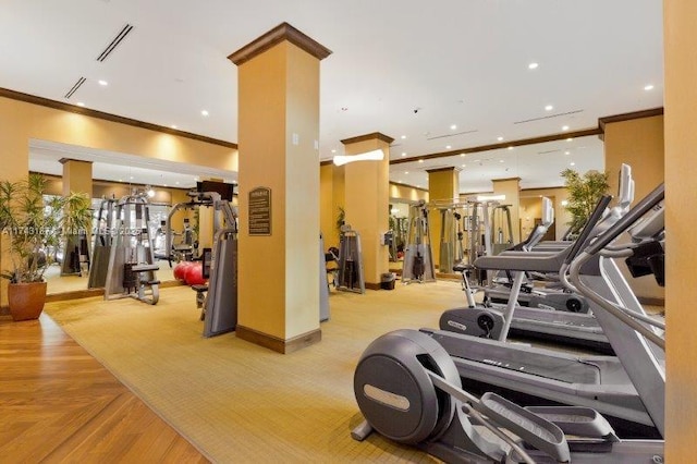 exercise room featuring recessed lighting, ornamental molding, and visible vents