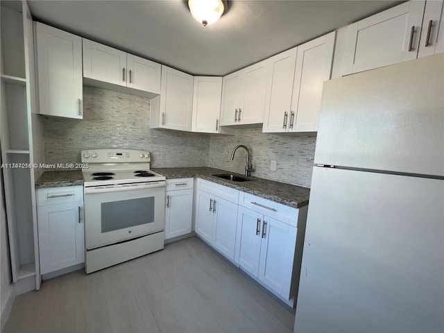 kitchen featuring sink, white appliances, tasteful backsplash, light hardwood / wood-style floors, and white cabinets