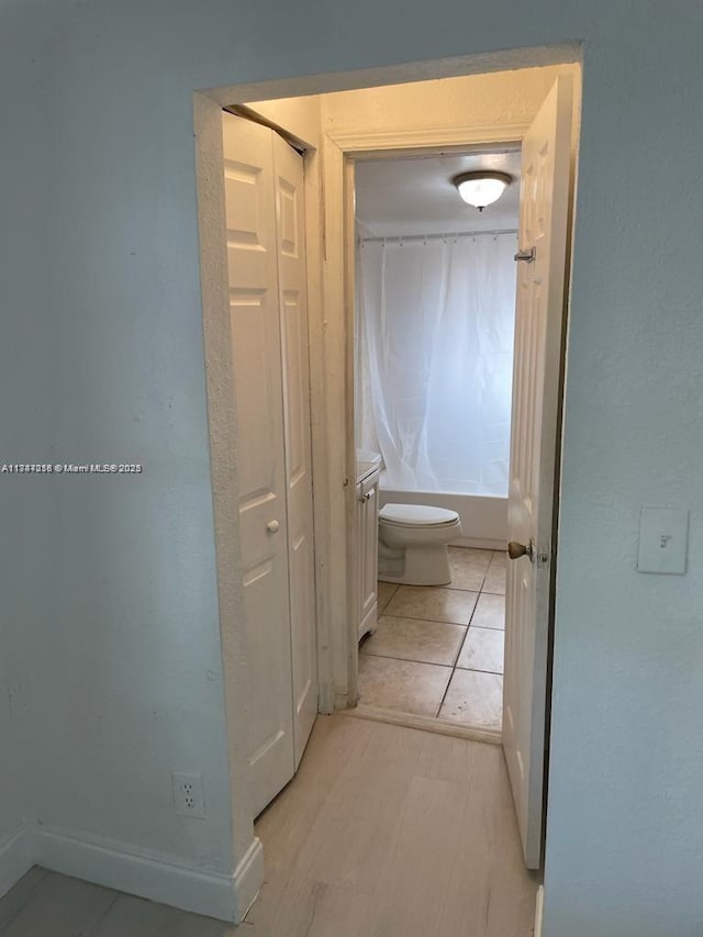 hall with light tile patterned floors