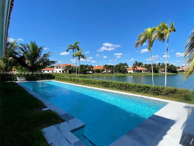 view of swimming pool with a water view