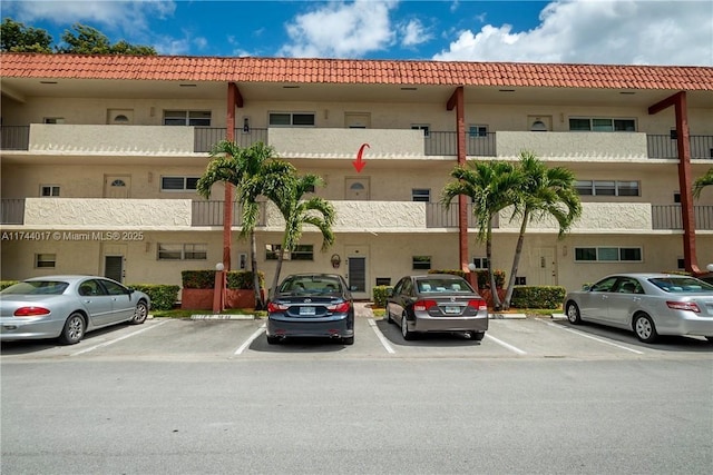 view of building exterior with uncovered parking