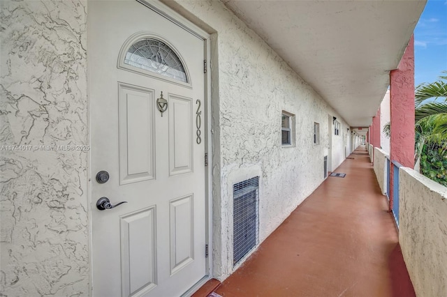 view of exterior entry with stucco siding