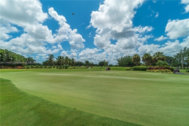 view of community featuring golf course view and a lawn