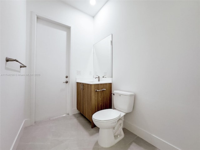 bathroom featuring vanity, toilet, and tile patterned flooring