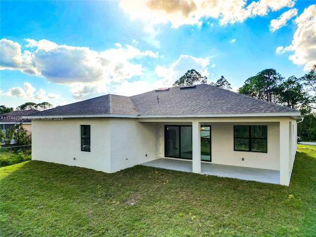 rear view of property with a patio and a yard