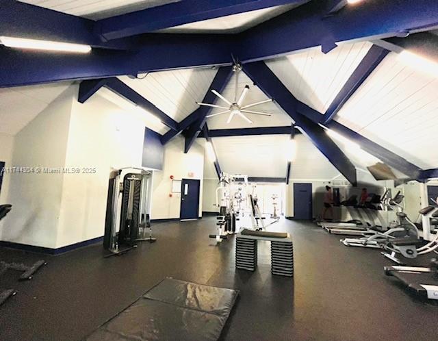 1470 NE 123rd St Unit A707, North Miami, FL 33161 - gym with vaulted ceiling, a ceiling fan, and baseboards