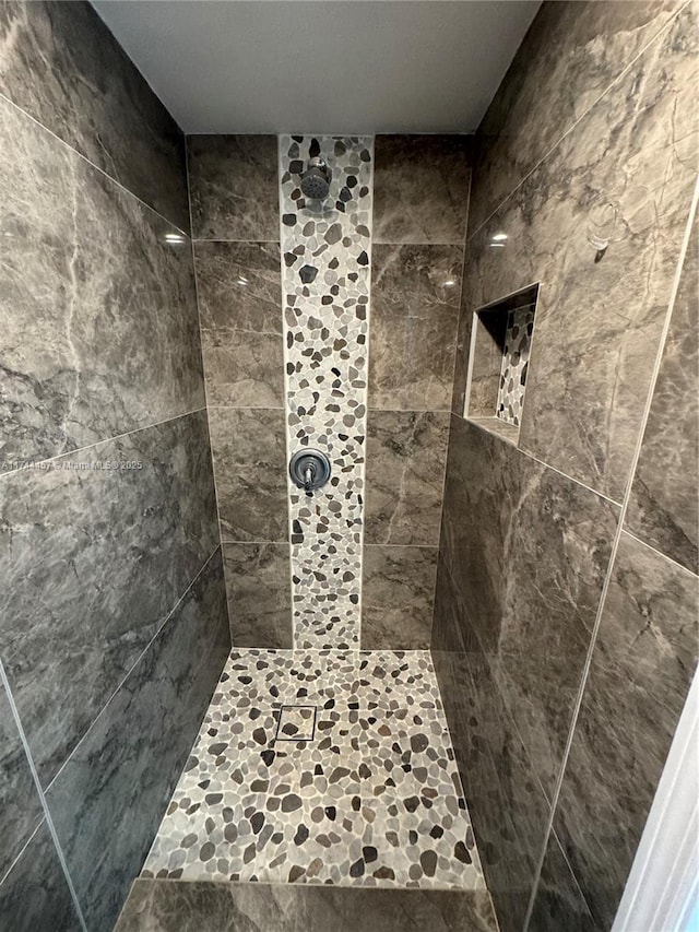 bathroom with a tile shower