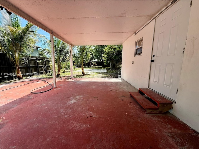 view of patio featuring entry steps and fence