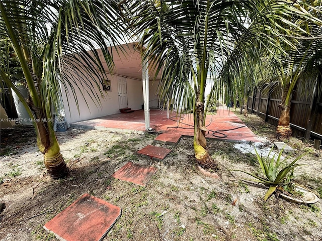 view of yard featuring fence and a patio