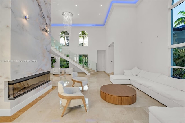 living room featuring a fireplace and a high ceiling