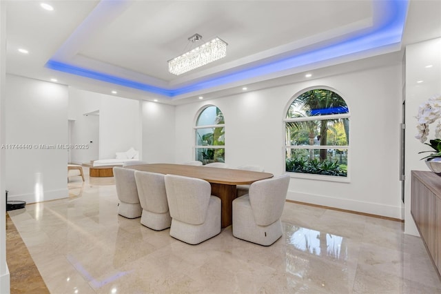 dining space featuring a raised ceiling