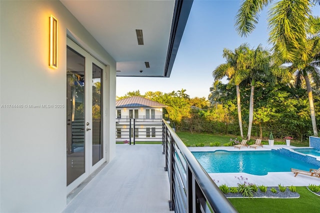 view of pool featuring french doors and a yard