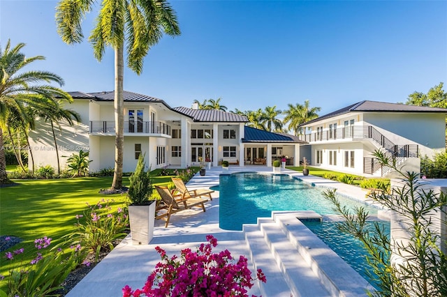 view of pool featuring a lawn and a patio