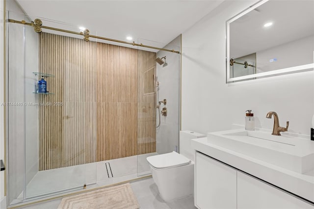 bathroom featuring vanity, toilet, and a shower with door