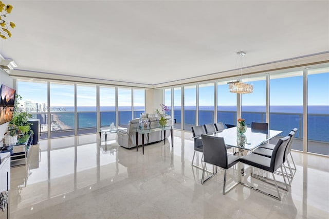 sunroom / solarium featuring a water view