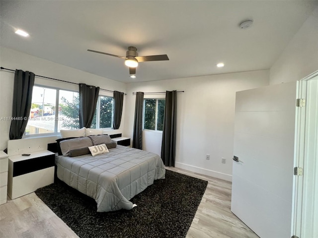 bedroom featuring light hardwood / wood-style flooring and ceiling fan