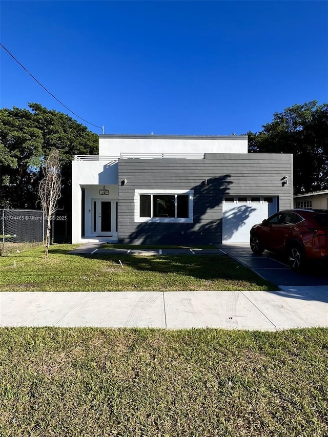 view of front of home with a garage and a front yard