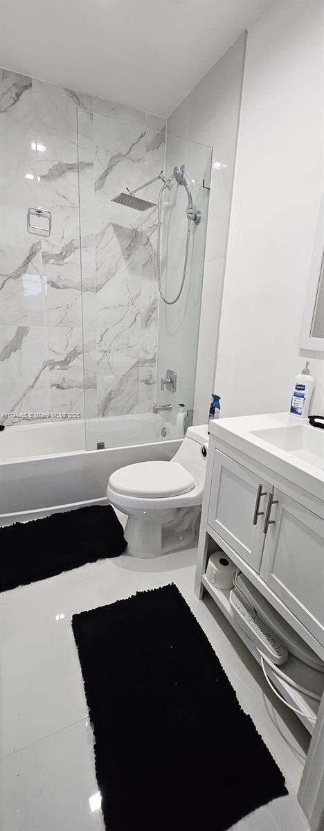 full bathroom with vanity, toilet, and tiled shower / bath combo