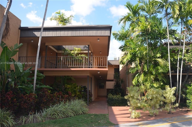 back of house with a balcony