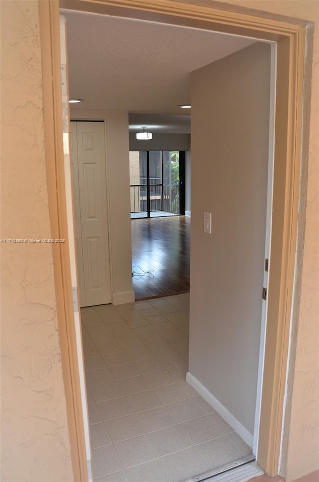 hallway featuring tile patterned floors