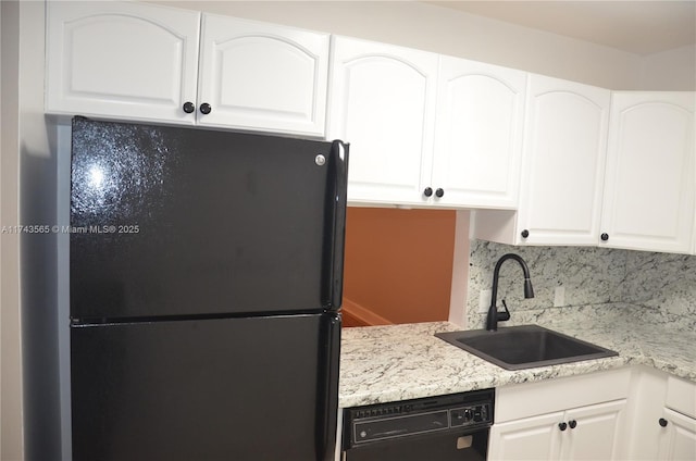 kitchen featuring white cabinets, sink, and black appliances