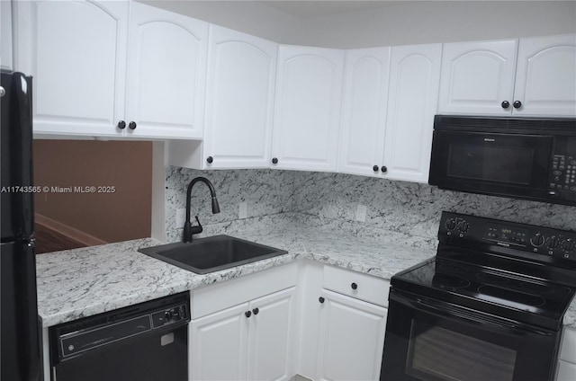 kitchen featuring sink, black appliances, and white cabinets