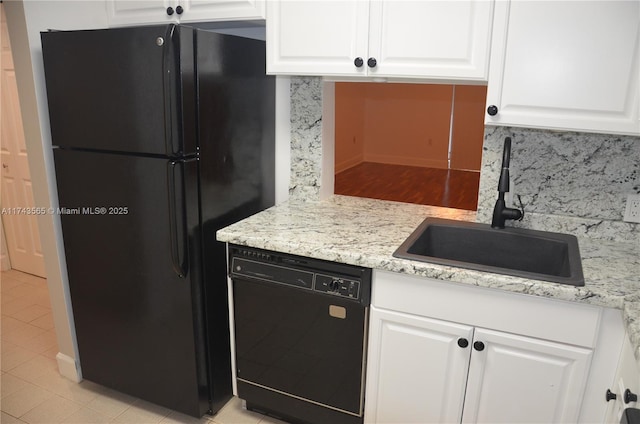 kitchen with white cabinets, sink, and black appliances