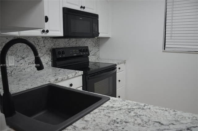 kitchen featuring white cabinetry, sink, decorative backsplash, light stone counters, and black appliances