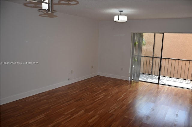 unfurnished room with dark hardwood / wood-style flooring