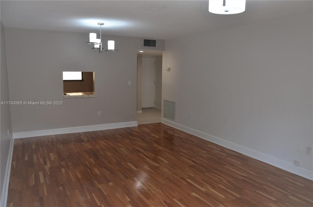 unfurnished room featuring dark hardwood / wood-style floors