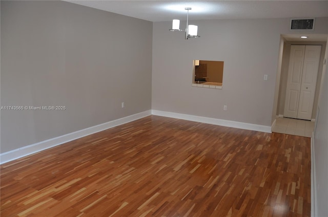 unfurnished room with hardwood / wood-style flooring