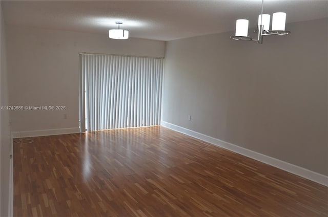 unfurnished room with dark hardwood / wood-style floors and a textured ceiling