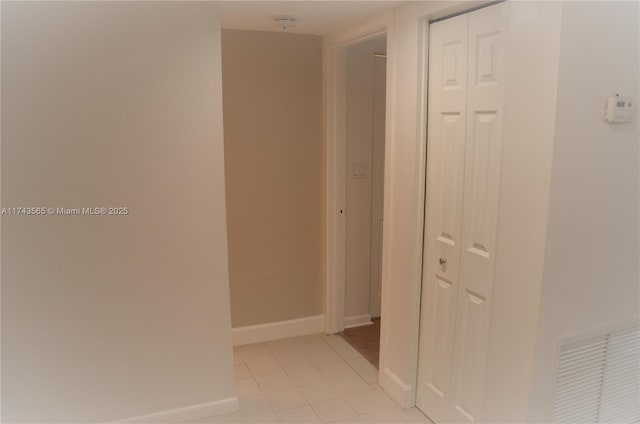 hall featuring light tile patterned floors