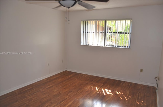 spare room featuring ceiling fan and dark hardwood / wood-style flooring