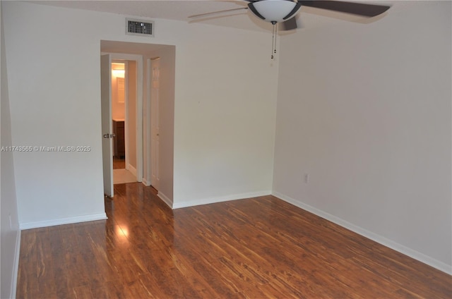 empty room with dark hardwood / wood-style floors and ceiling fan