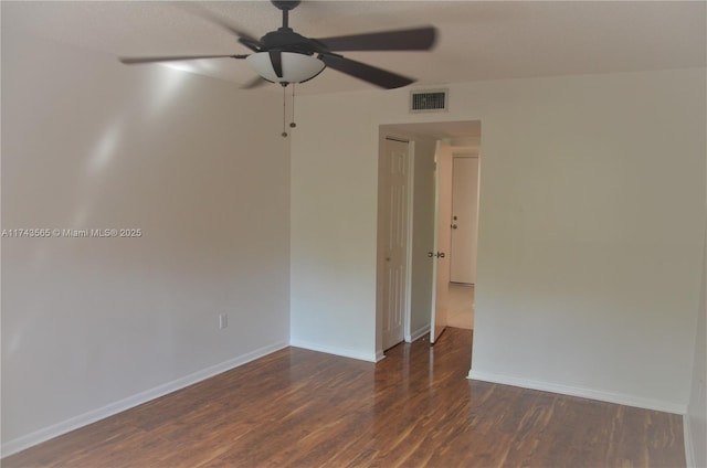 empty room featuring ceiling fan and dark hardwood / wood-style floors