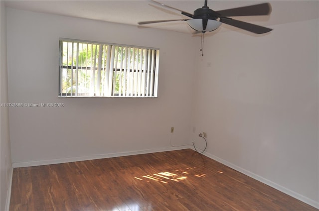 spare room with ceiling fan and dark hardwood / wood-style flooring