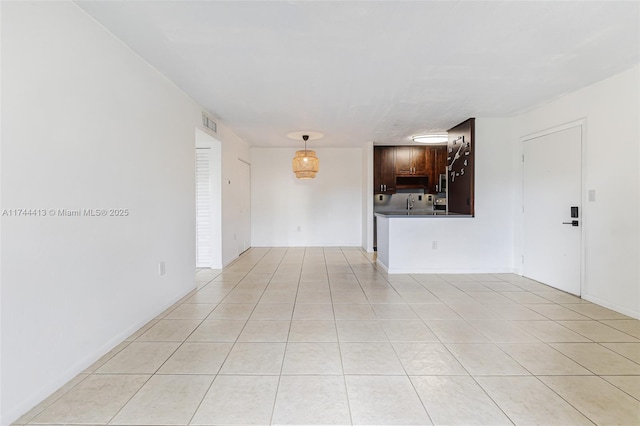 unfurnished living room with light tile patterned flooring