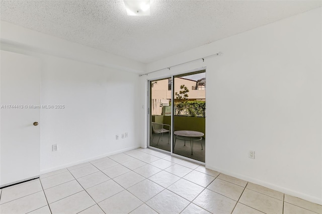 tiled empty room with a textured ceiling