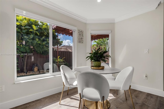 dining room featuring hardwood / wood-style flooring and ornamental molding