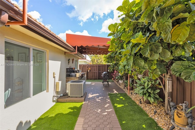 view of yard with a patio and central AC