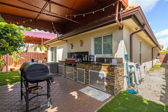 view of patio with exterior kitchen and sink