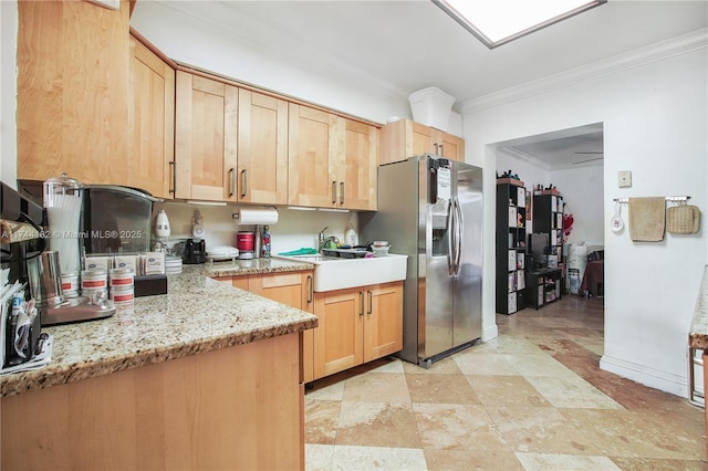 kitchen with light brown cabinetry, stainless steel fridge with ice dispenser, ornamental molding, and light stone countertops